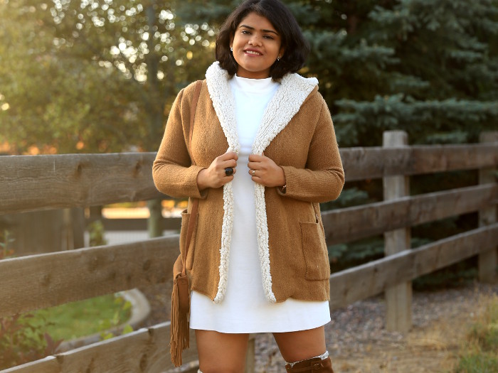 Get cozy in winter, with shades of white and tan. Pair the tan fleece lined coat and suede OTK boots with white mock neck dress.